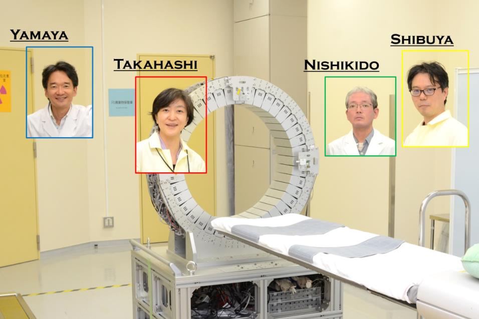 Researchers and a prototype PET scanner being remodeled to detect the lifetime of positrons